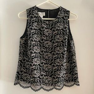 SLEEVELESS BLACK/GOLD/BEIGE LACE TOP OVER A BLACK LINING.